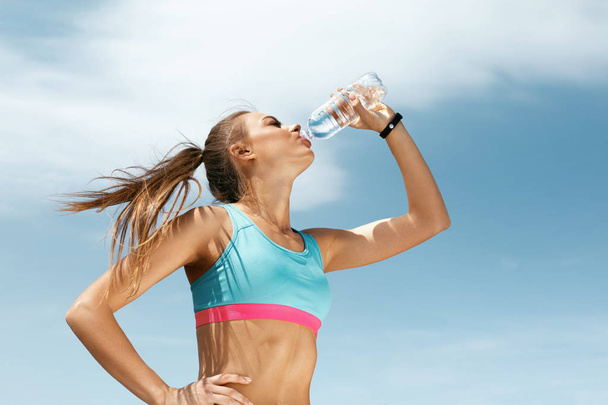 Woman Drinking Water After Running. - 写真・画像