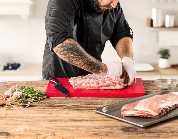 Man cooking meat steak on kitchen - Photo, image