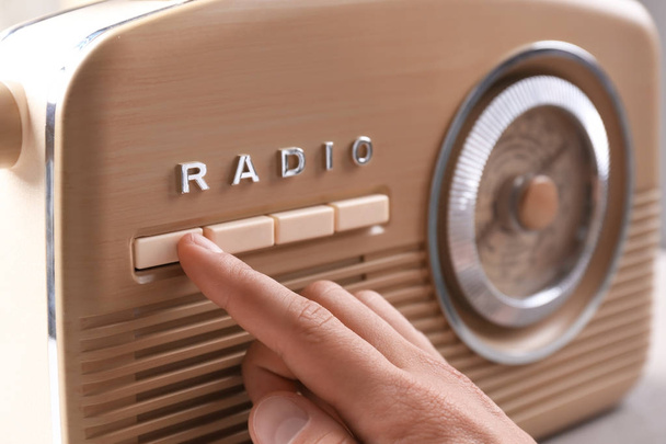 Person tuning retro radio, closeup - Fotografie, Obrázek