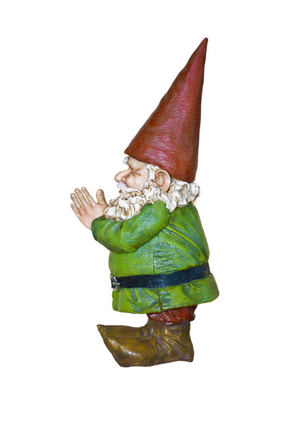 Gnome with red hat and green suit in side profile view/Gnome in green suit and red pointed hat in side view with hands together - Photo, Image