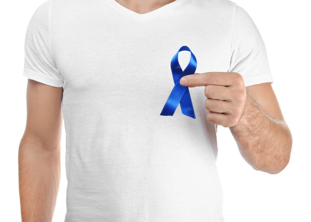 Young man holding blue ribbon  - Фото, изображение
