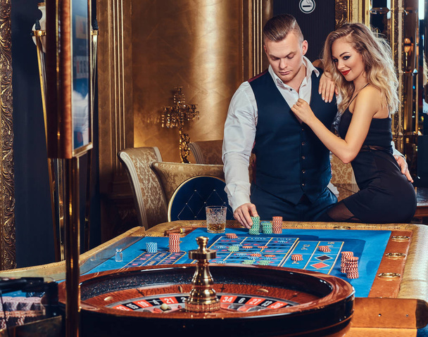 Man and woman in a casino. - Φωτογραφία, εικόνα