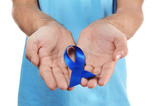 Young man holding blue ribbon  - Foto, afbeelding