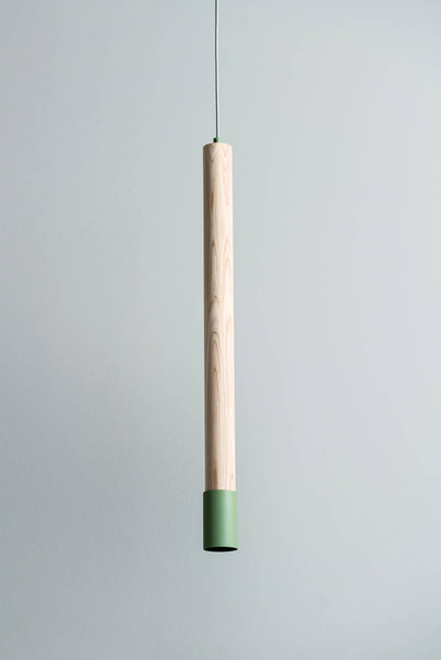 Hanging wooden tube lamp with metal part - Valokuva, kuva