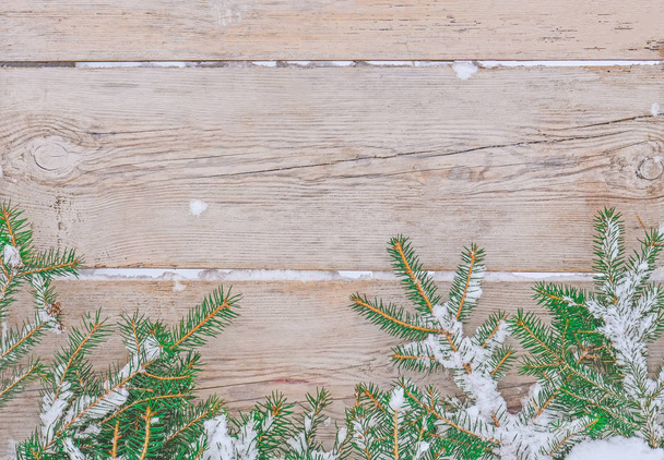 Christmas snowy wooden background. Christmassnowy  fir tree border - Photo, Image