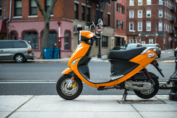 Colorful Moped loked up on city street. City transportation concept. - Foto, afbeelding