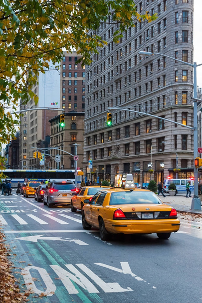 Traffic in a street with yellow taxis and flatiron building in t - Photo, image
