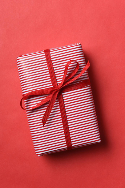 Christmas present wrapped in red and white striped paper - 写真・画像
