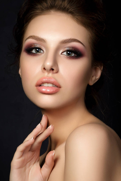 Portrait of young beautiful woman with evening make up touching  - Fotó, kép