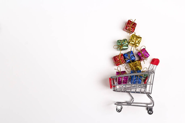Shopping trolley with gift boxes and cope space on white backgro - Fotografie, Obrázek