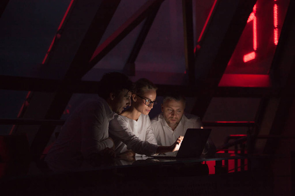Group of business people working in a night office. - Фото, изображение