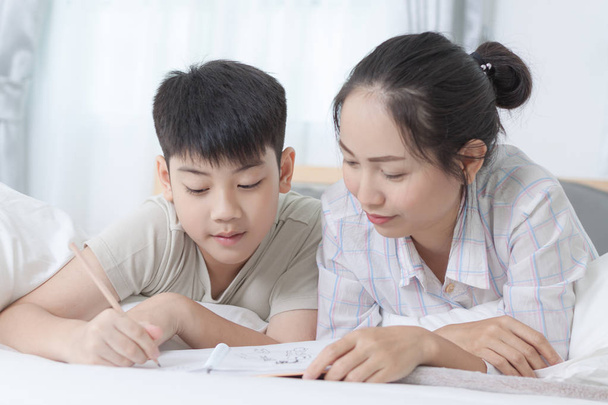 Sister helping brother to writing homework - Photo, Image