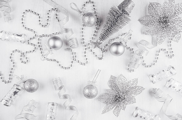 New year decorations of silvery glitter on white wood background. - 写真・画像