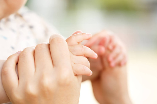 Family scene , closeup parent and baby holding hand together - Φωτογραφία, εικόνα