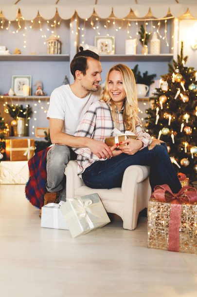 Sweet couple opening Christmas gifts - Φωτογραφία, εικόνα
