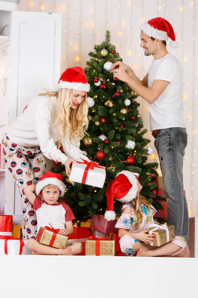 Happy family decorates Christmas pine - Photo, image