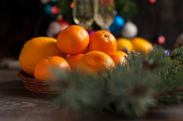 Tavolo di anno nuovo tradizionale, mandarini, champagne, albero di Natale e luci di anno nuovo
 - Foto, immagini