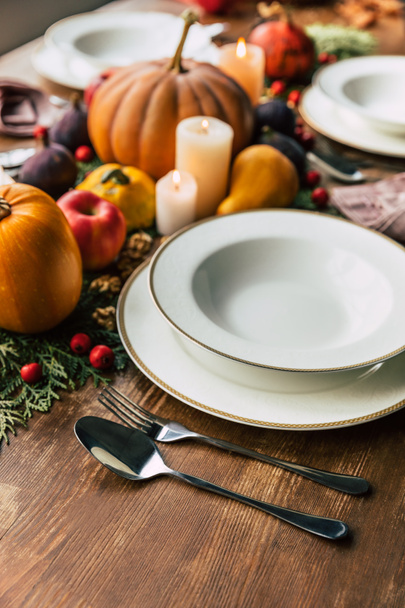 Close-up shot of table setting with beautiful autumn decor on wooden table - Фото, изображение