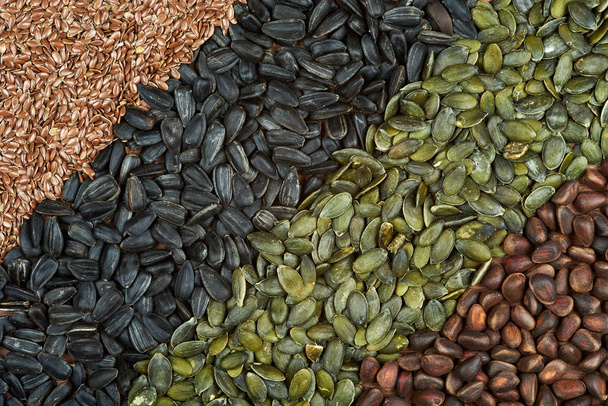 Tekstury o zmiennym, nasiona słonecznika, Orzeszki piniowe, siemię lniane i nasiona dyni. - Zdjęcie, obraz