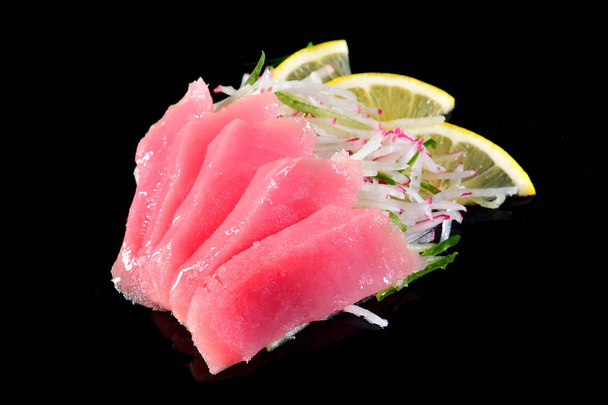 Tuna sashimi over black background, concept menu of a Japanese r - Photo, Image