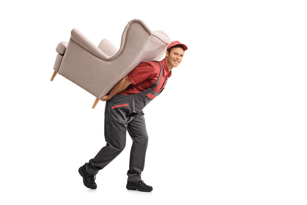 Mover carrying an armchair on his back - Fotoğraf, Görsel