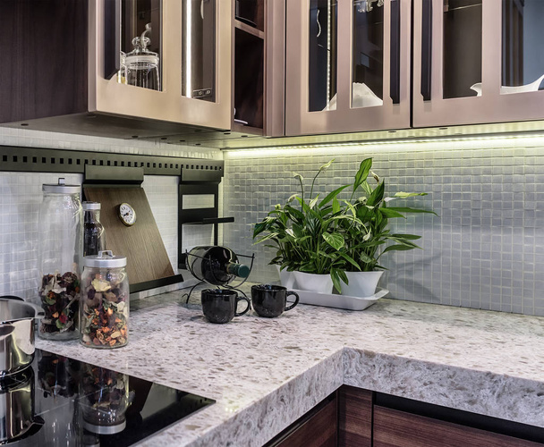 Comfortable and functional kitchen in high-tech style. Marble countertop and apron from ceramic mosaic tiles. - Photo, Image