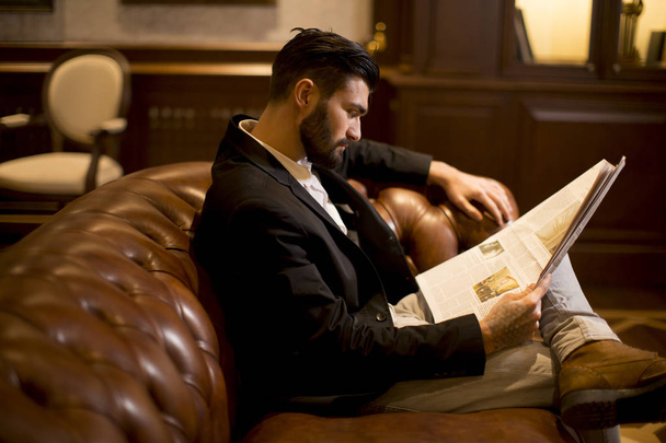 Modern businessman reading newspaper - Фото, изображение