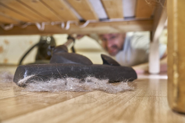 Vacuuming floor under a bed - Photo, Image