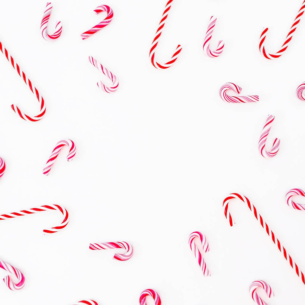 伝統的なクリスマスのお菓子の杖に分離された白い背景に、コピー領域。フラット横たわっていた休日の概念. - 写真・画像