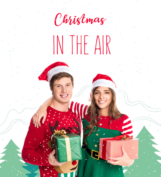 Paar in Weihnachtsmützen mit Geschenken - Foto, Bild
