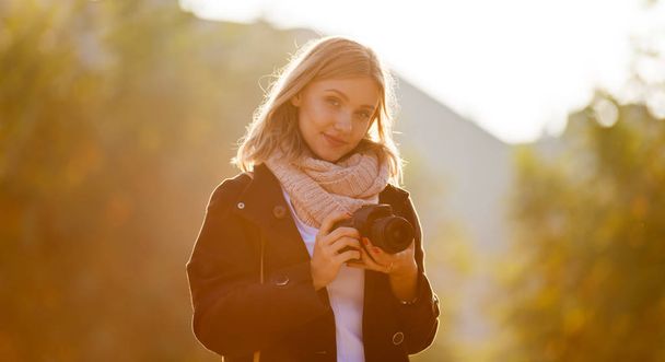 Girl outdoor with camera during sunset in the city - Φωτογραφία, εικόνα
