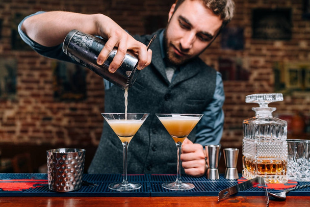 Close up details of barman pouring fancy alcoholic drinks at party - Фото, зображення