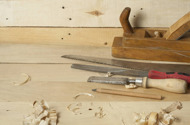 Carpentry concept.Joiner carpenter workplace. Construction tools on wooden table with sawdust. - Фото, изображение