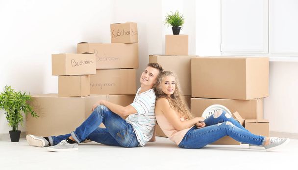Young couple with moving boxes  - Photo, image