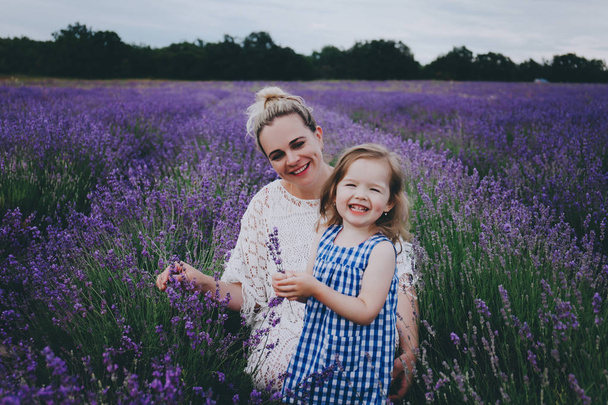 Mom and daughter in lavender. - Zdjęcie, obraz