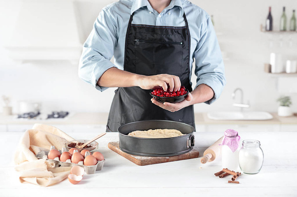 A cook with eggs on a rustic kitchen against the background of mens hands - Foto, Imagem