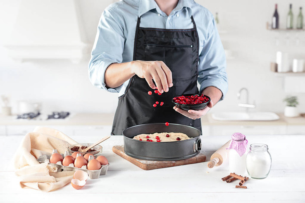 A cook with eggs on a rustic kitchen against the background of mens hands - Foto, Bild