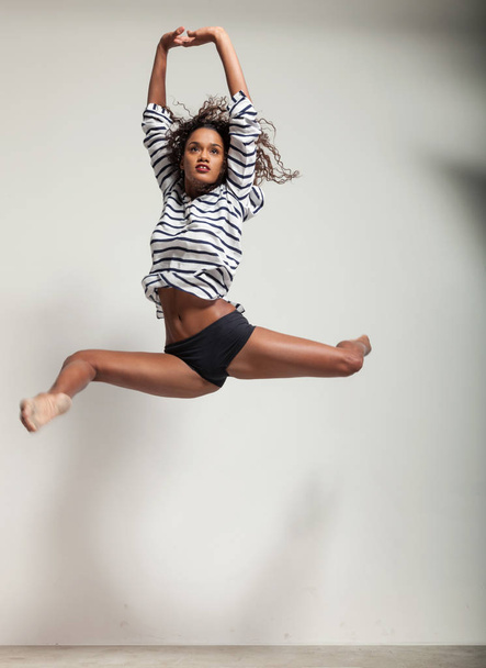 young beautiful dancer jump in a studio - Photo, image
