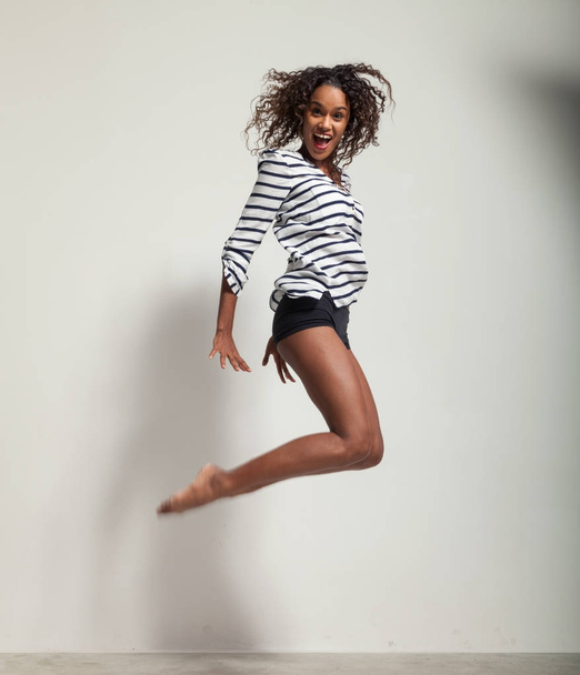 young beautiful dancer jump in a studio - Photo, Image