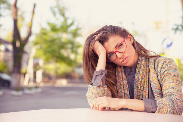 Stressed sad young woman sitting outdoors. City urban life style stress  - Фото, зображення