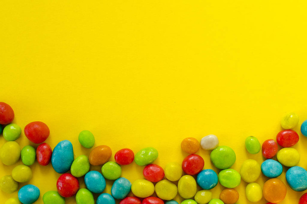 multicolored candy on yellow background - Photo, Image