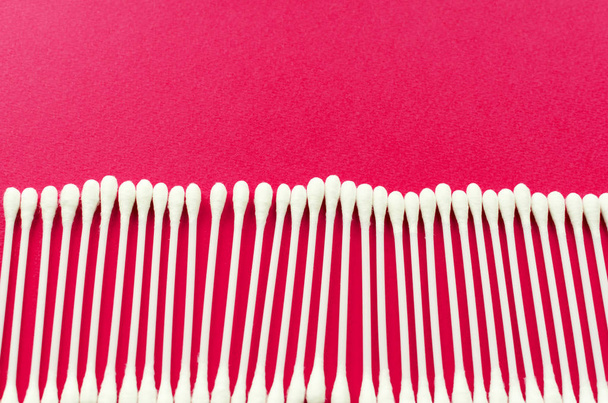 line of ear sticks on pink background - Photo, Image
