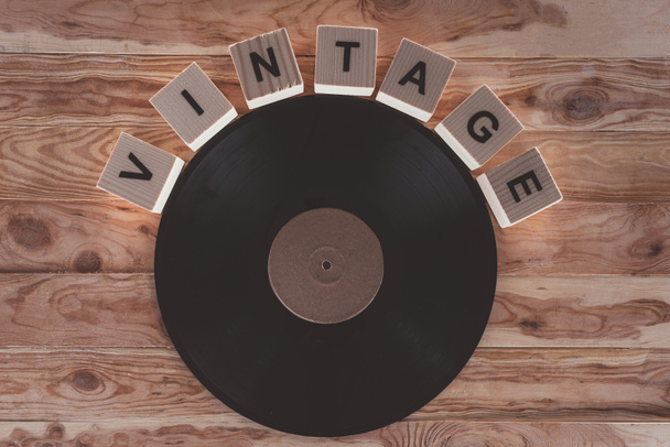 top view of cubes with letters and vinyl record over wooden background - Photo, Image