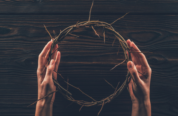 cropped image of woman holding crown of thorns in hands  - Photo, Image