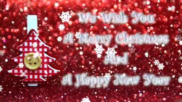we wish you a merry christmas and a happy new year text, wooden reindeer with a red background - Footage, Video