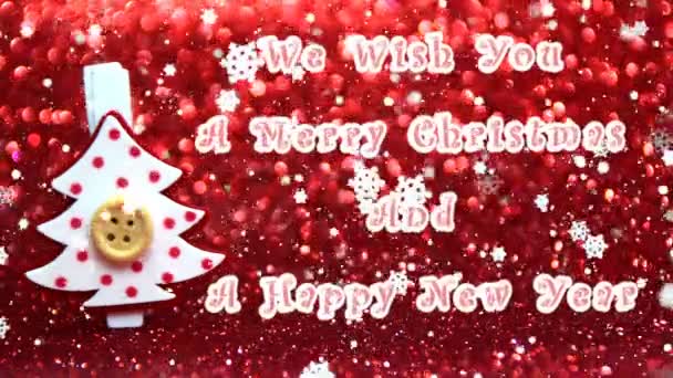 Wij wensen u een vrolijk kerstfeest en een gelukkig Nieuwjaar-tekst, decoratieve rode en witte kerstboom en het effect van vallende sneeuw - Video