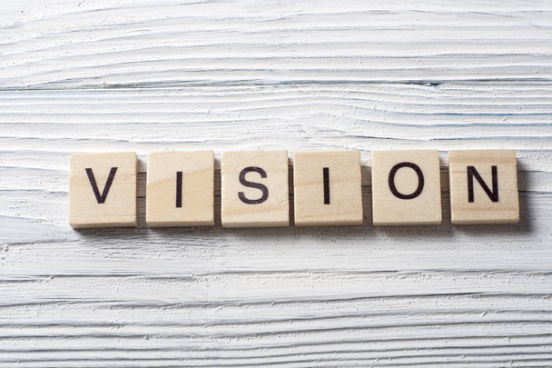 VISION word on wood abc cubes at wooden background. - Photo, image