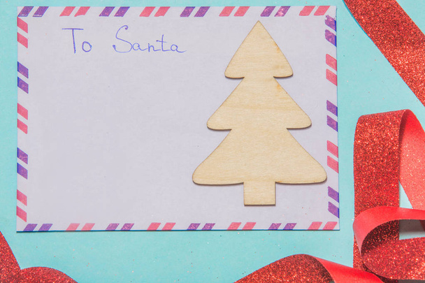 Letter to santa claus a letter of wish list on a blue background - Фото, изображение
