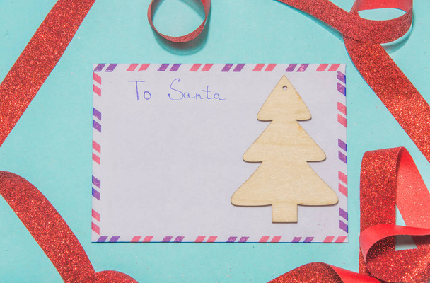 Letter to santa claus a letter of wish list on a blue background - Фото, изображение