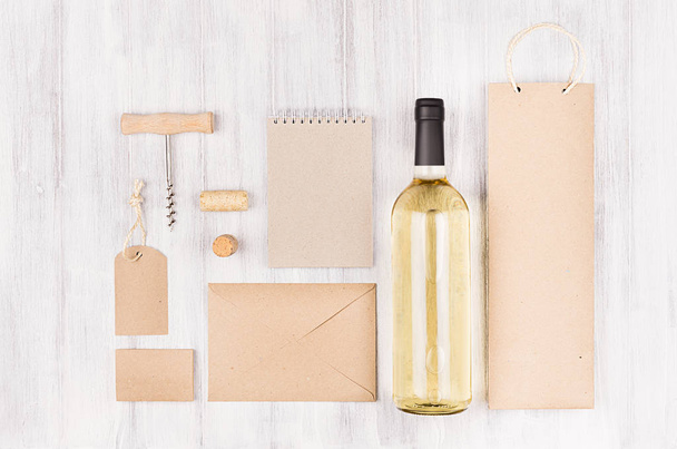 Corporate identity mock up for wine industry with bottle white wine on soft white wood background.  - Photo, image